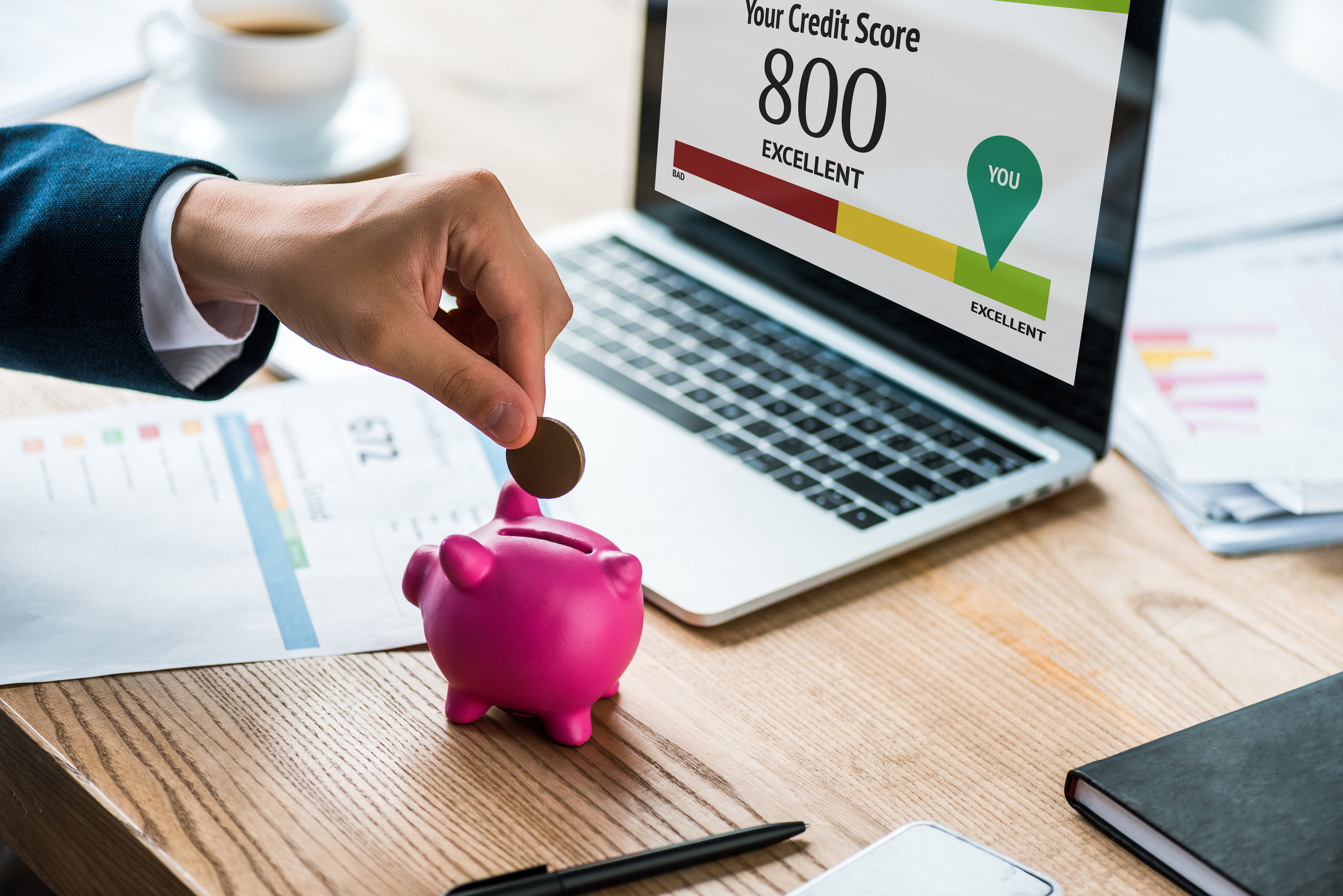 cropped-view-of-businessman-putting-coin-into-pink-2022-12-16-20-50-43-utc